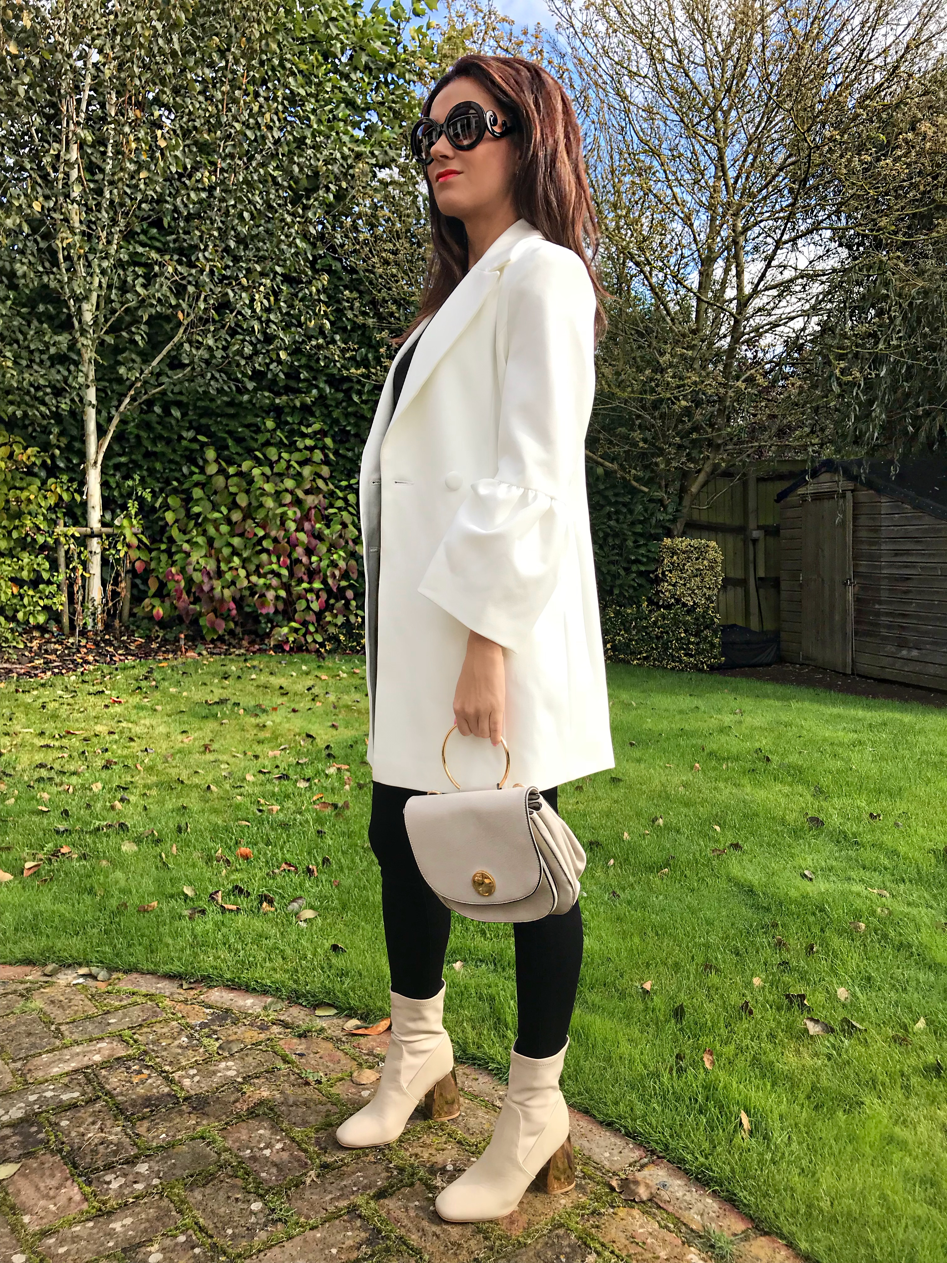 Michelle Keegan Fluted Sleeve Double Breasted Blazer | Lost Ink Bubble Heel Sock Ankle Boot - Cream | Next White Circle Detail Saddle Bag | Prada Baroque sunglasses | Zara top