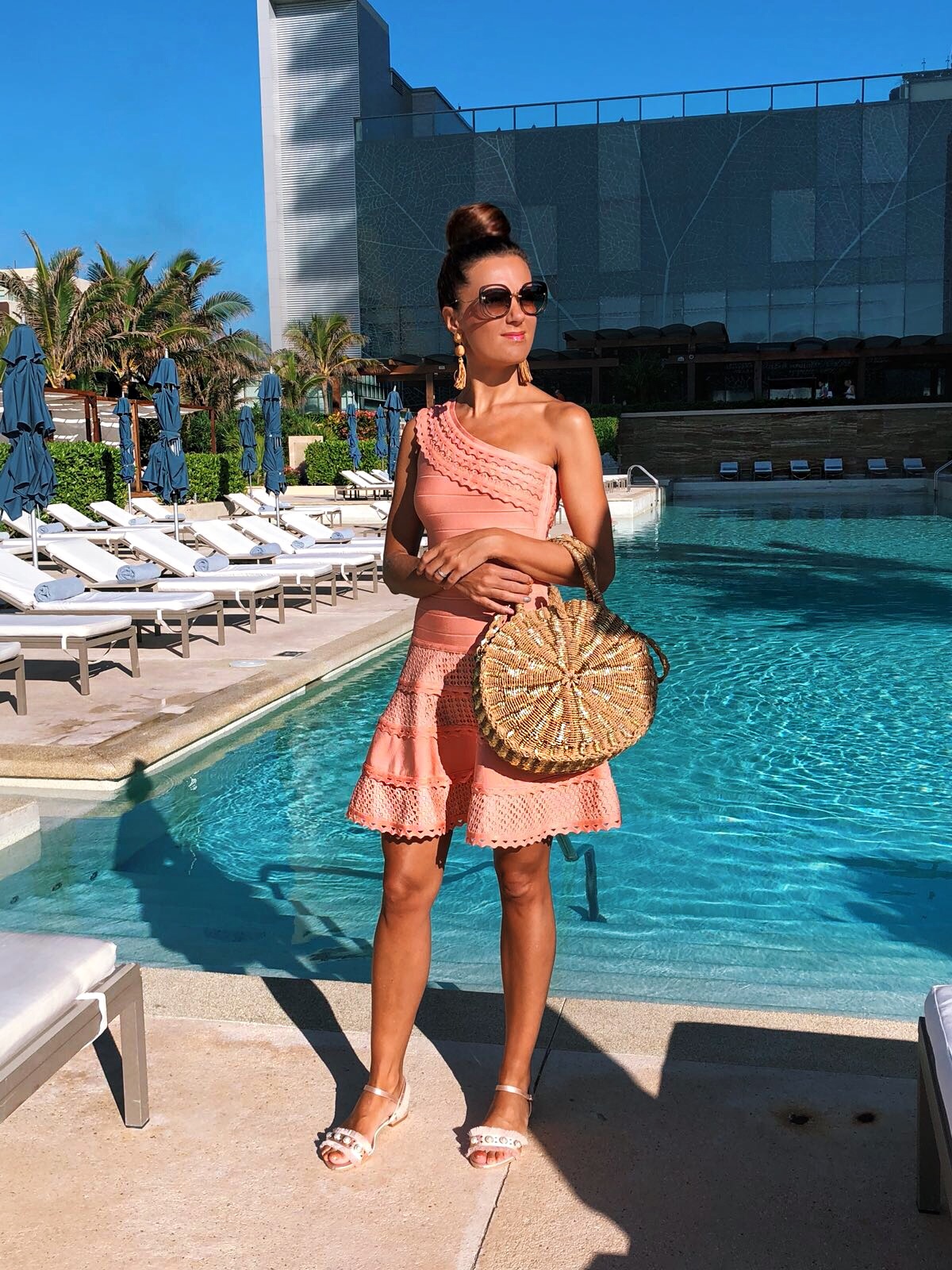 Cancun Mexico | Secrets the Vine hotel Forever Unique Structured One Shoulder Skater Dress With Lace Inserts | Glamorous Pearl Embellished Satin Sandals | Swarovski hoop earrings | Miu Miu sunglasses | ASOS DESIGN Wrapped Bead & Tassel Earrings | South Beach Round Gold Woven Straw Cross Body Bag