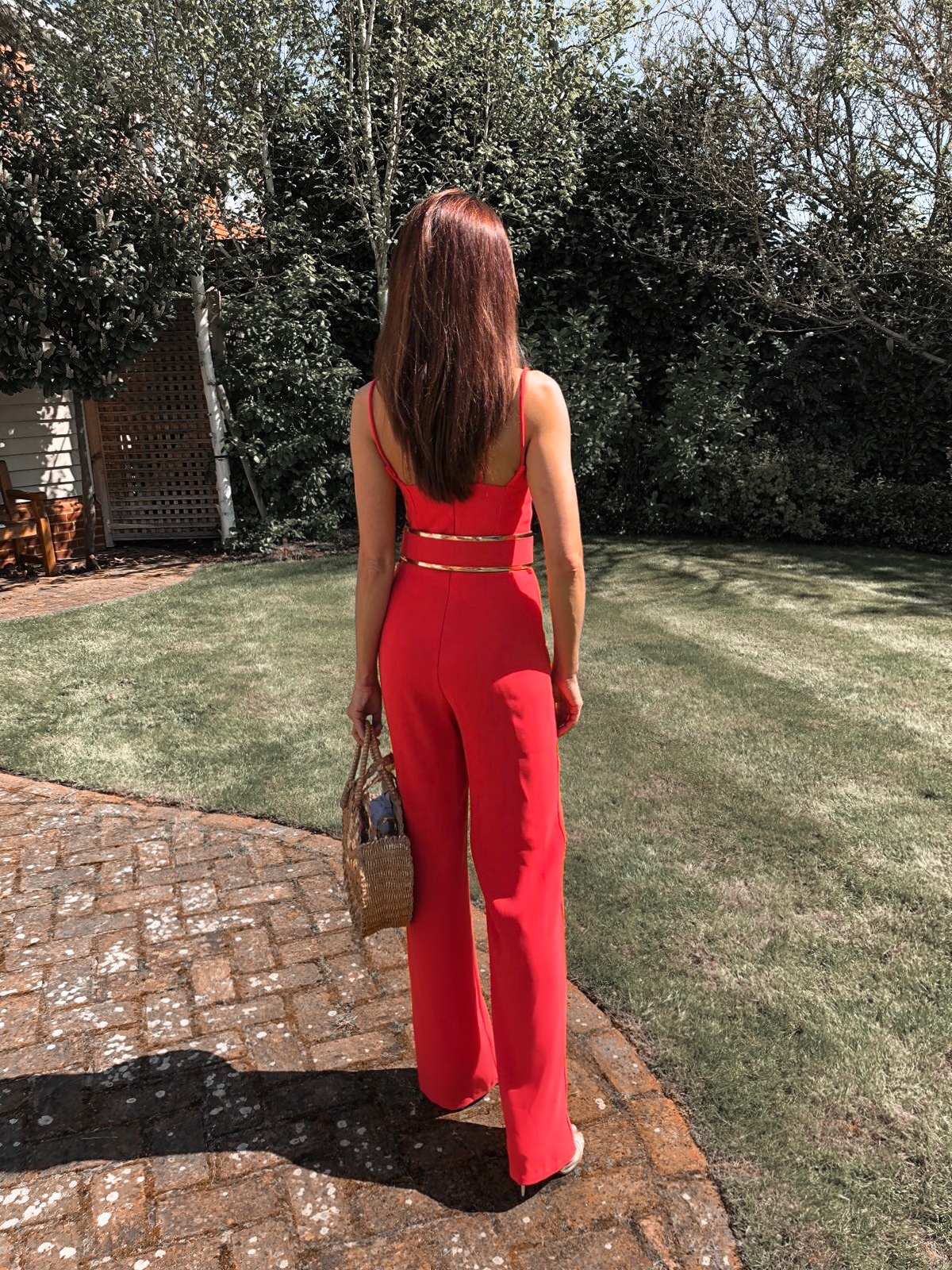 BROOKE - BRIGHT CORAL DOUBLE STRAP JUMPSUIT WITH GOLD WAISTBAND | South Beach Round Gold Woven Straw Cross Body Bag | Elegant Duchess Boutique Bohemian earrings