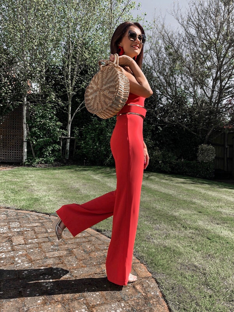 BROOKE - BRIGHT CORAL DOUBLE STRAP JUMPSUIT WITH GOLD WAISTBAND | South Beach Round Gold Woven Straw Cross Body Bag | Elegant Duchess Boutique Bohemian earrings