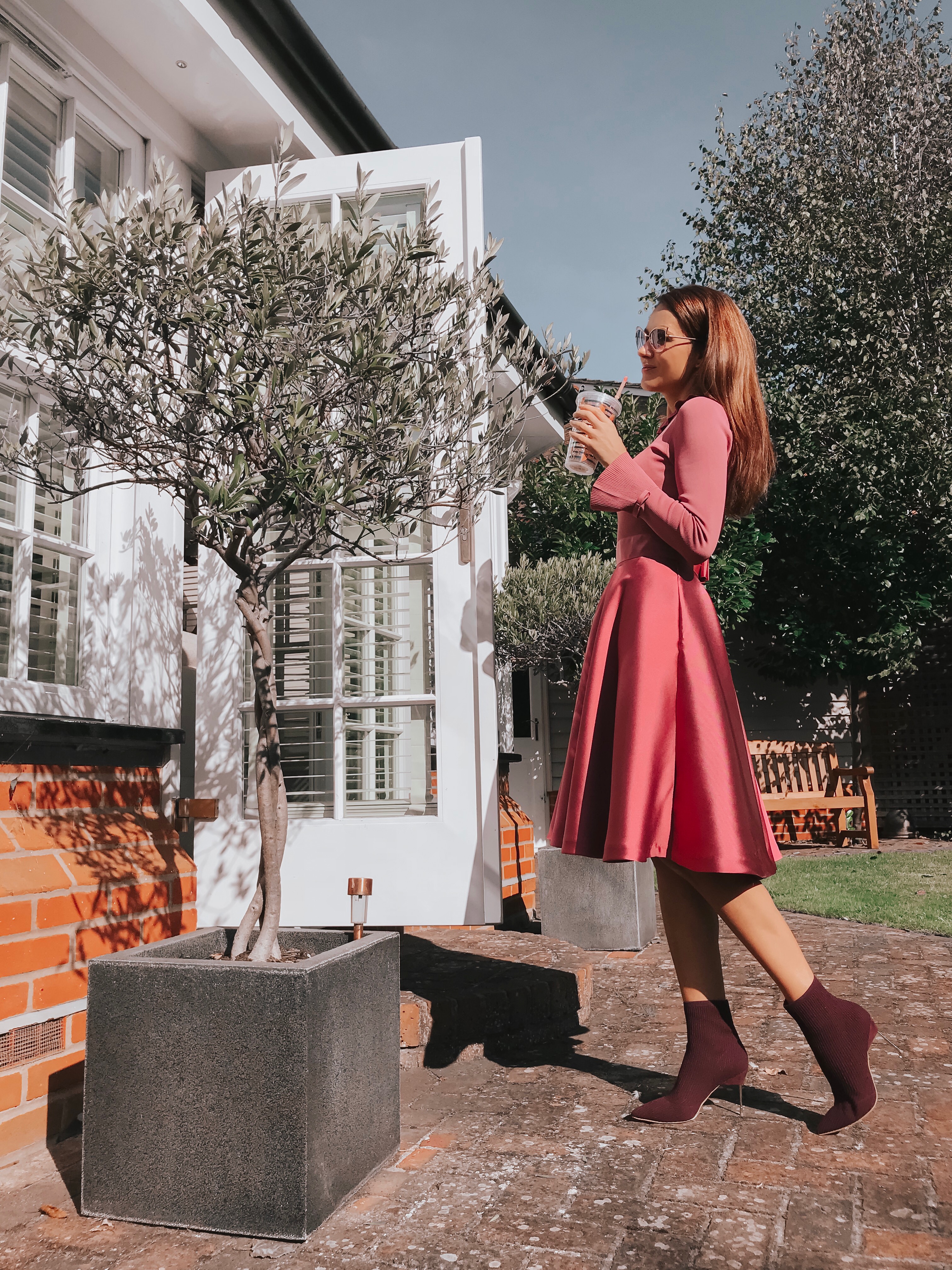 Elegant Duchess Fashion Ted Baker Pink Zadi Skater Dress | Kurt Geiger London Barbican-Wine-(Fabric) Knit Ankle Boot | Miu Miu Sunglasses | Swarovski earrings | Accessorize clutch bag