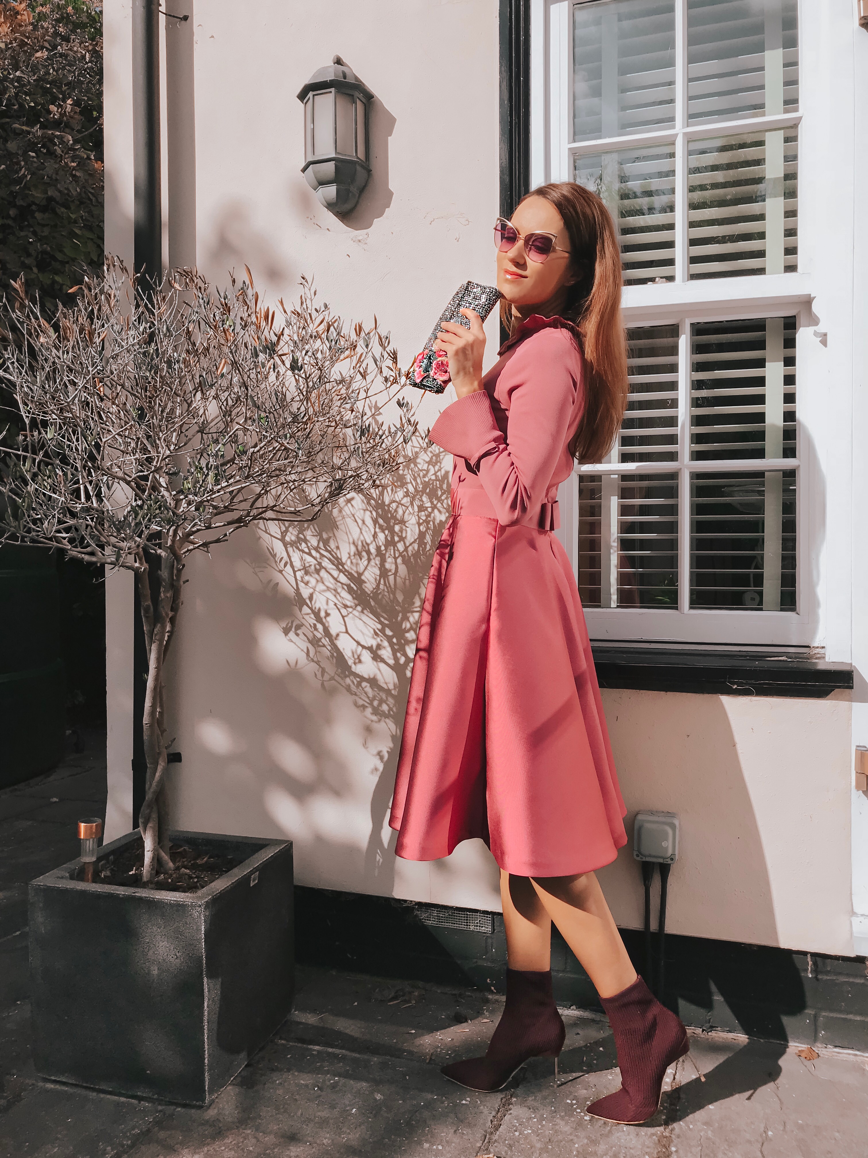 Elegant Duchess Fashion Ted Baker Pink Zadi Skater Dress | Kurt Geiger London Barbican-Wine-(Fabric) Knit Ankle Boot | Miu Miu Sunglasses | Swarovski earrings | Accessorize clutch bag