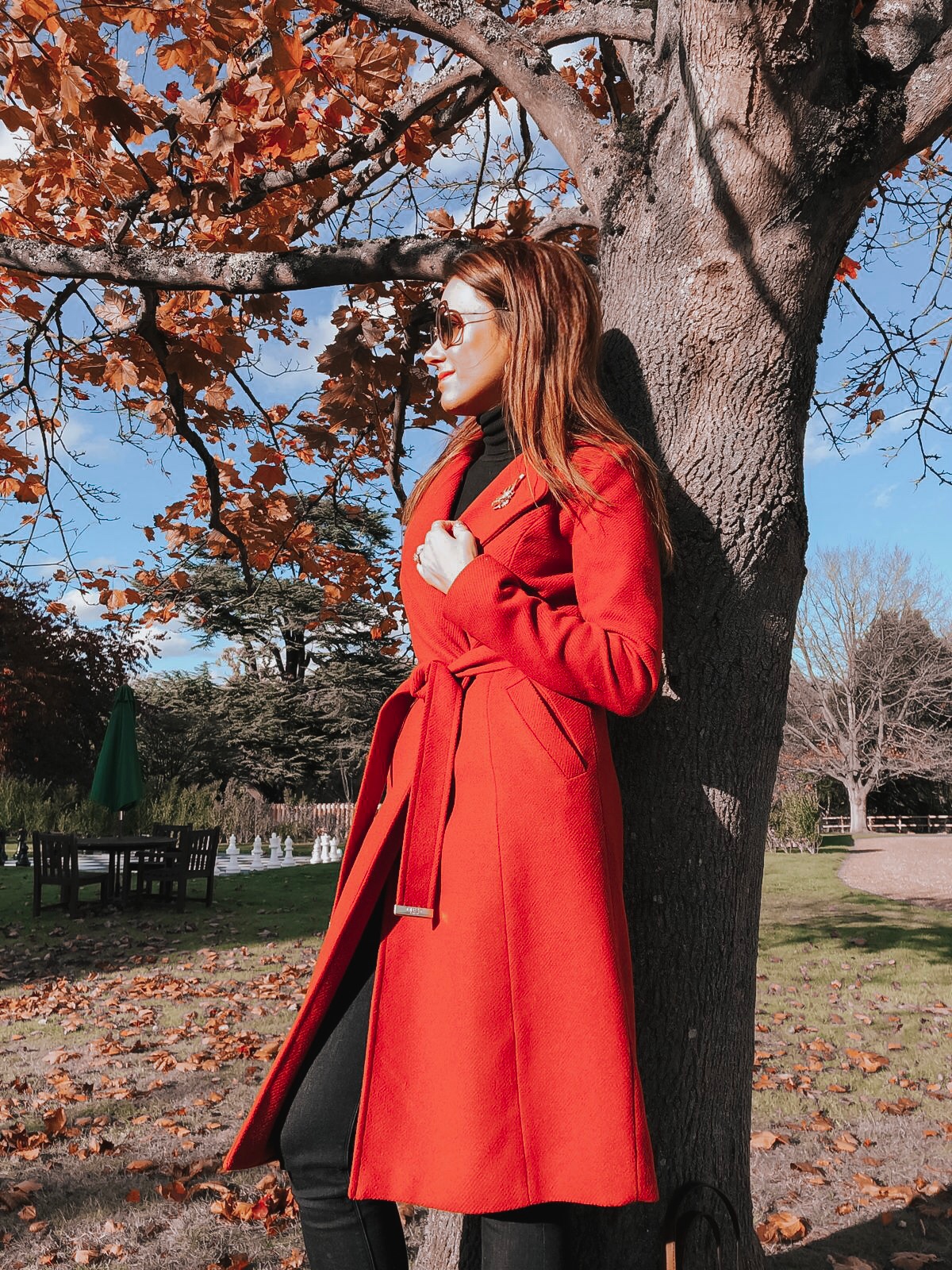 Lipsy Rust Wrap Coat | Elegant Duchess Boutique Brooch | Replay Jeans | Miu Miu sunglasses | Swarovski earrings