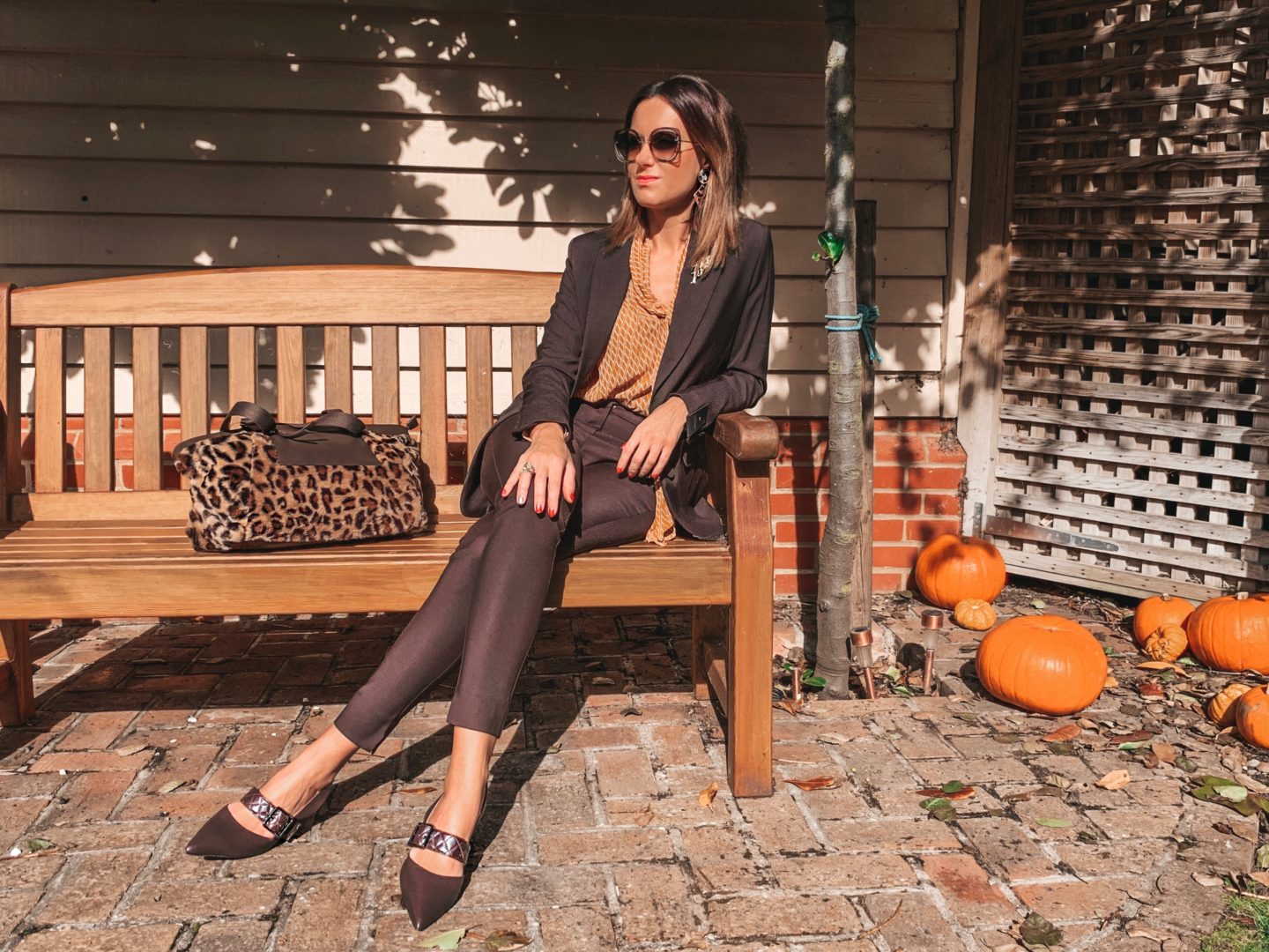 Next Chocolate Skinny Zip Trousers | Next Chocolate Longline Single Breasted Jacket | Next Ochre Print Tie Neck Top | Next Chocolate Leather Buckle Slingbacks | Elegant Duchess Boutique Brooch | Miu Miu sunglasses | Amazon earrings | Next Large Shopper Bag