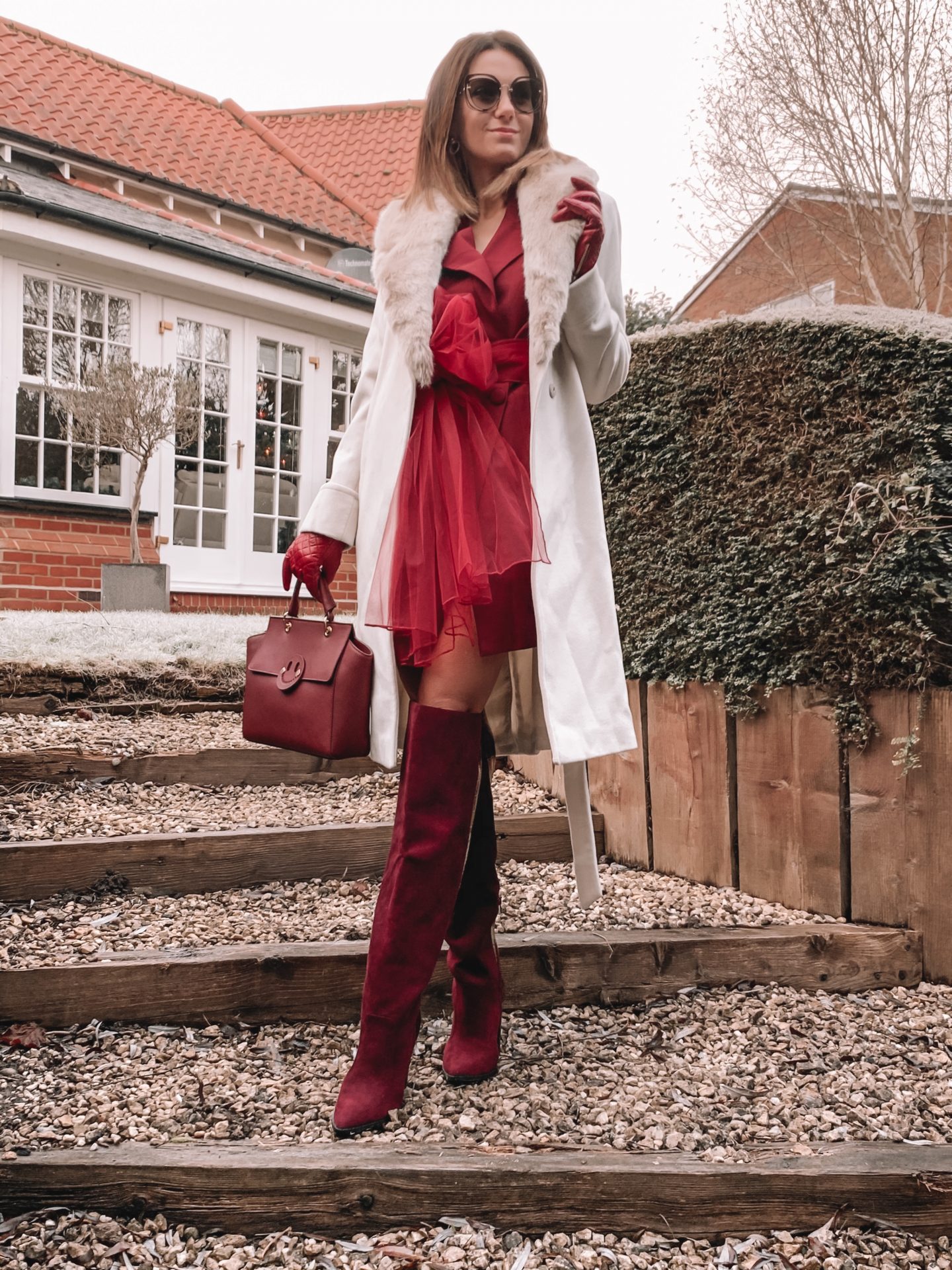 Missguided blazer dress with mesh bow waist detail in burgundy | Miu Miu sunglasses | Dune burgundy gloves | Mix/Hill & Friends Satchel Bag | Lauren Ralph Lauren® Faux Fur Trim Wool Wrap Coat | River Island Red Dark High Wide Leg Boots