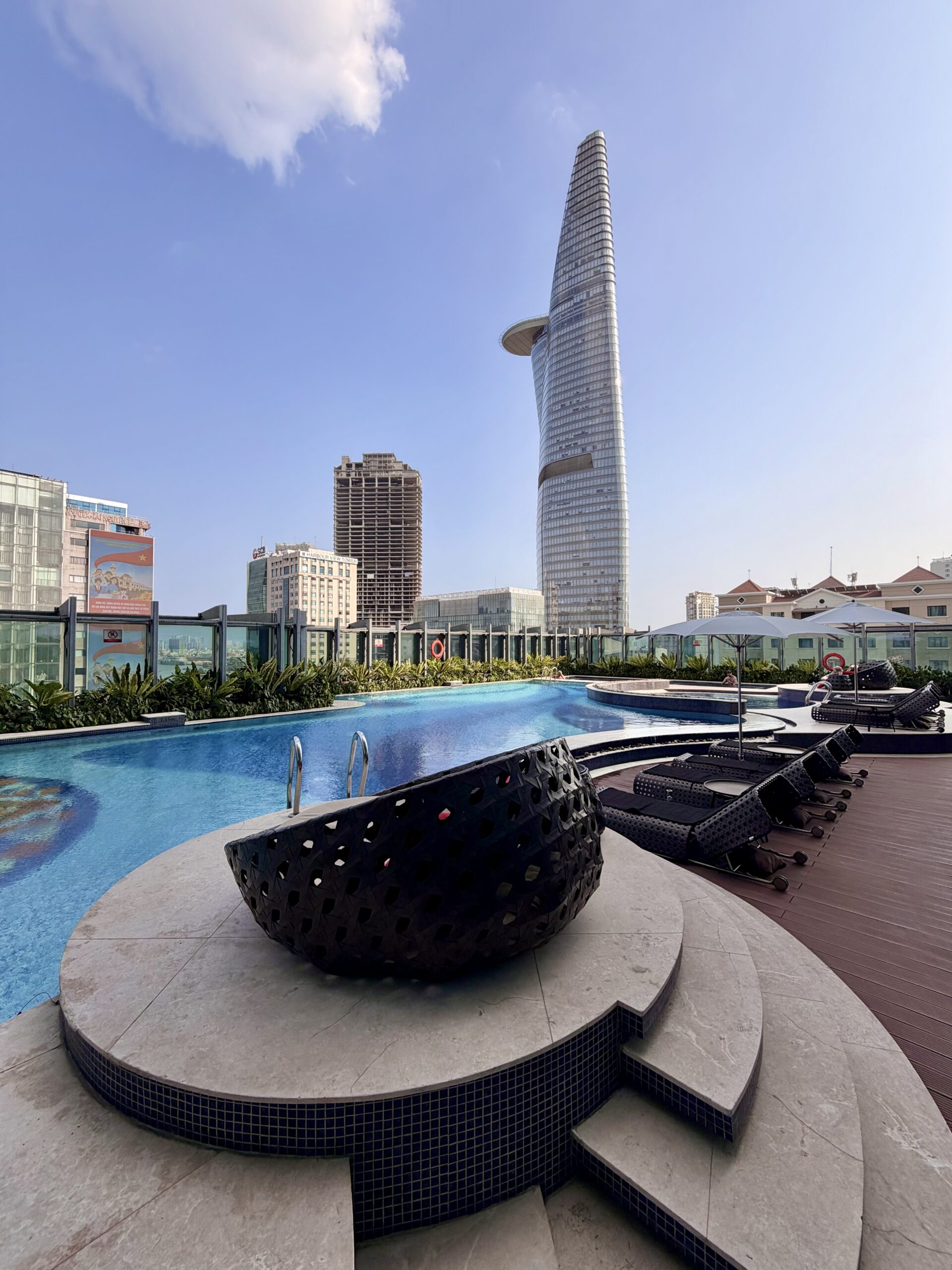 Outdoor pool at The Reverie Saigon surrounded by loungers in the heart of Ho Chi Minh City Outdoor pool at The Reverie Saigon surrounded by loungers in the heart of Ho Chi Minh City